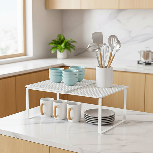 Expandable kitchen counter shelf with a white metal organizer for mugs, bowls, and utensils.